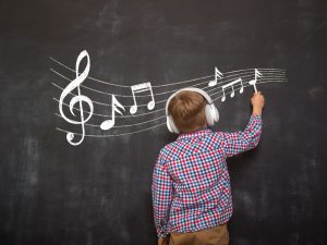 Boy writing music notes