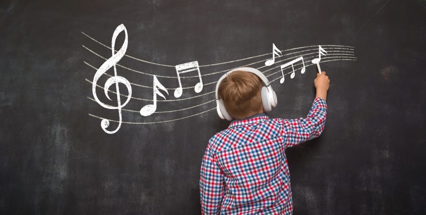 Boy writing music notes