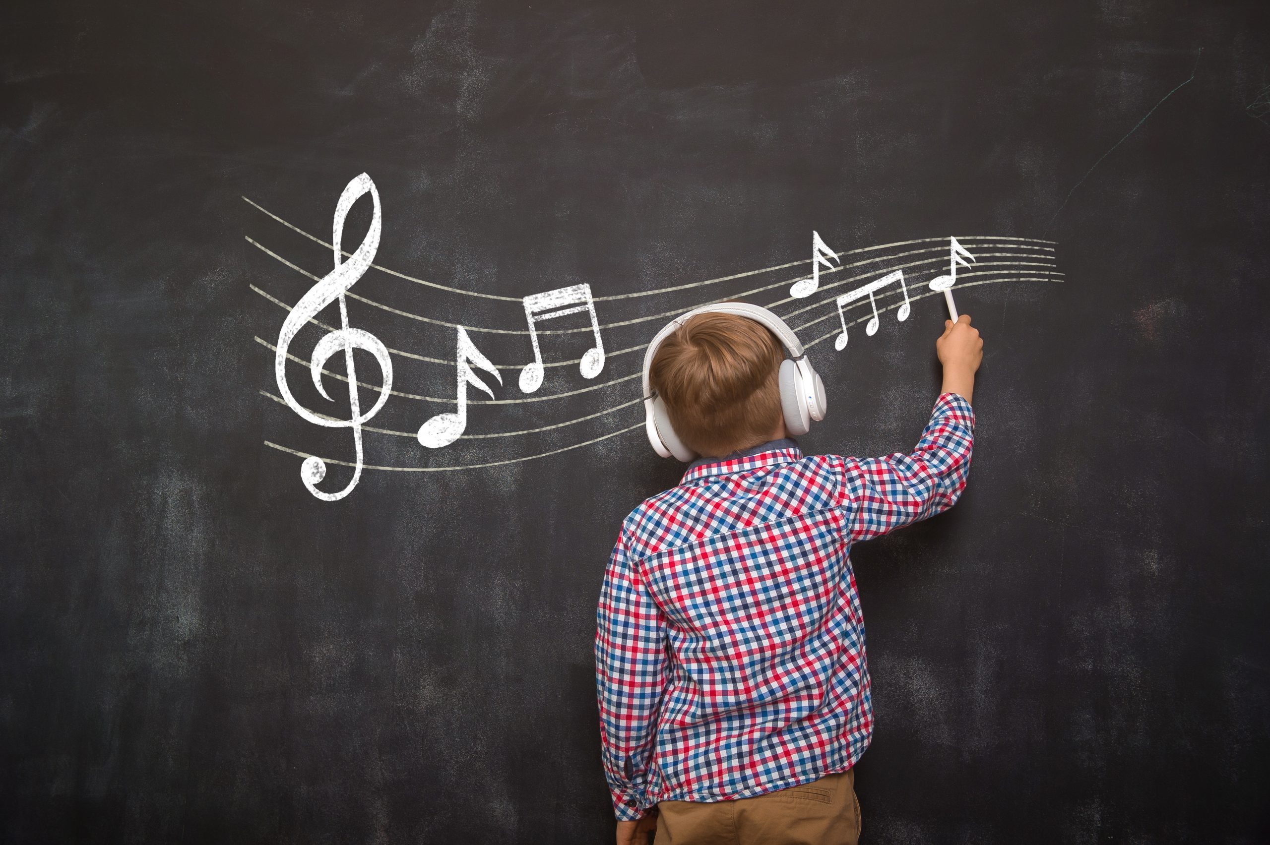Boy writing music notes